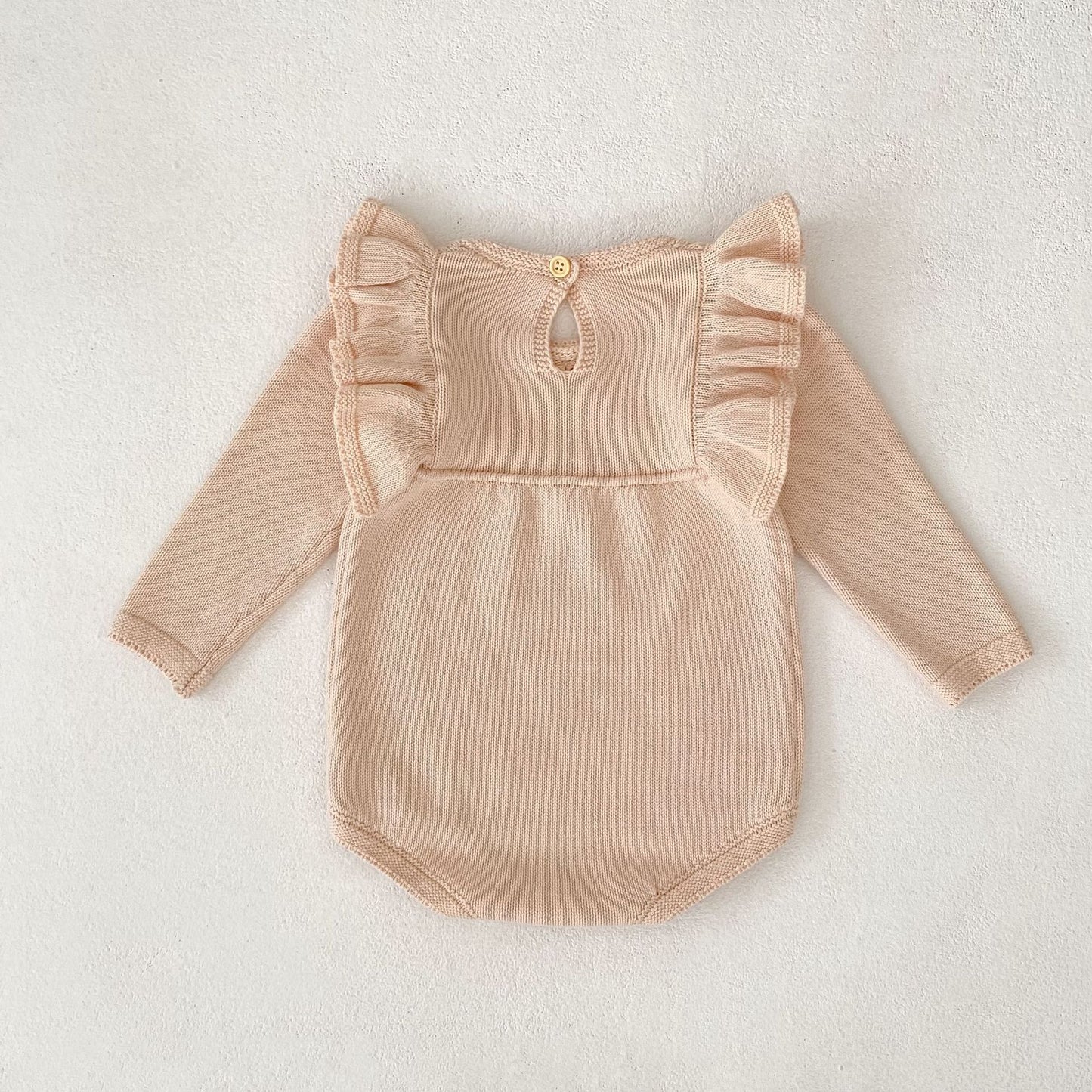 パステルピンクフリルニットロンパース