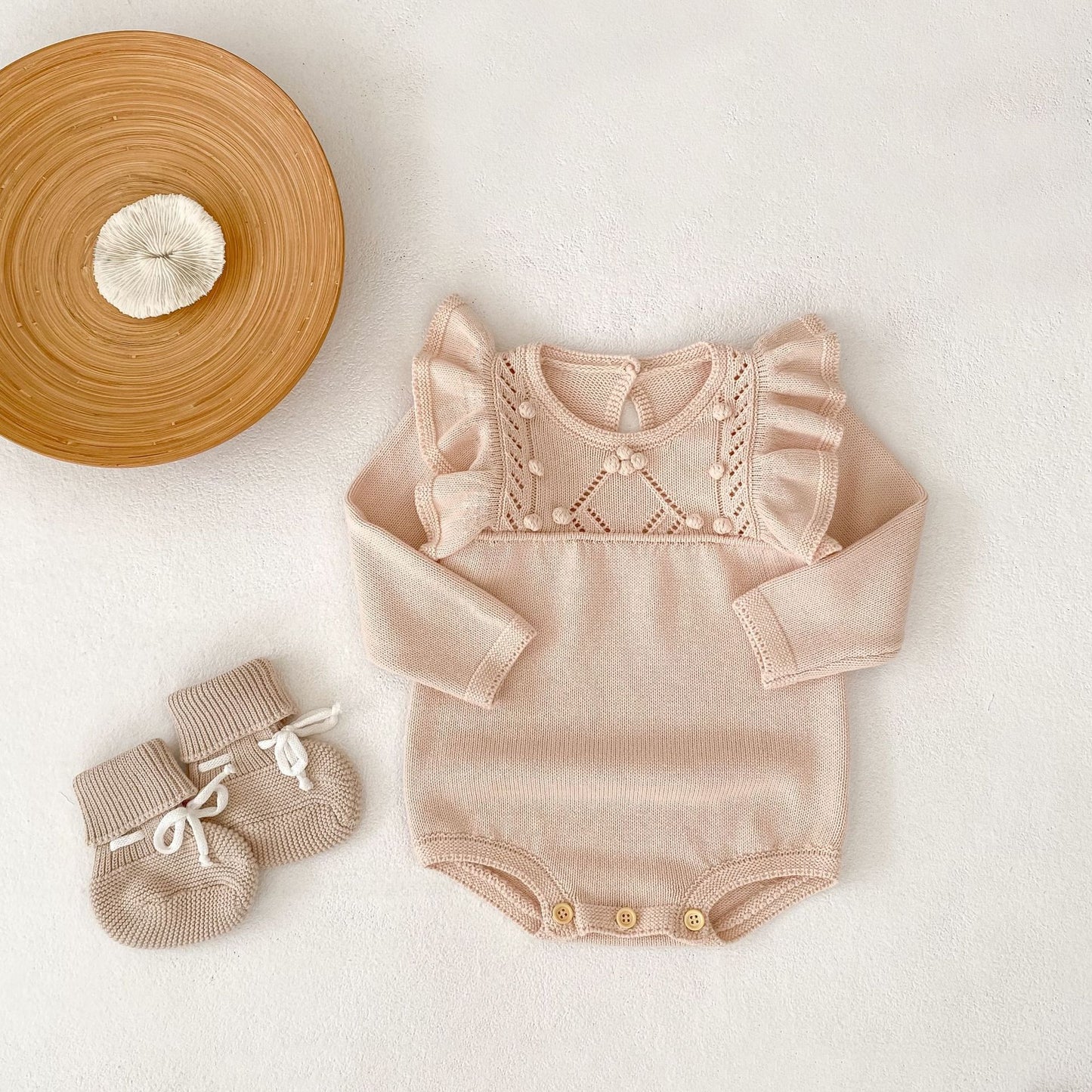 パステルピンクフリルニットロンパース