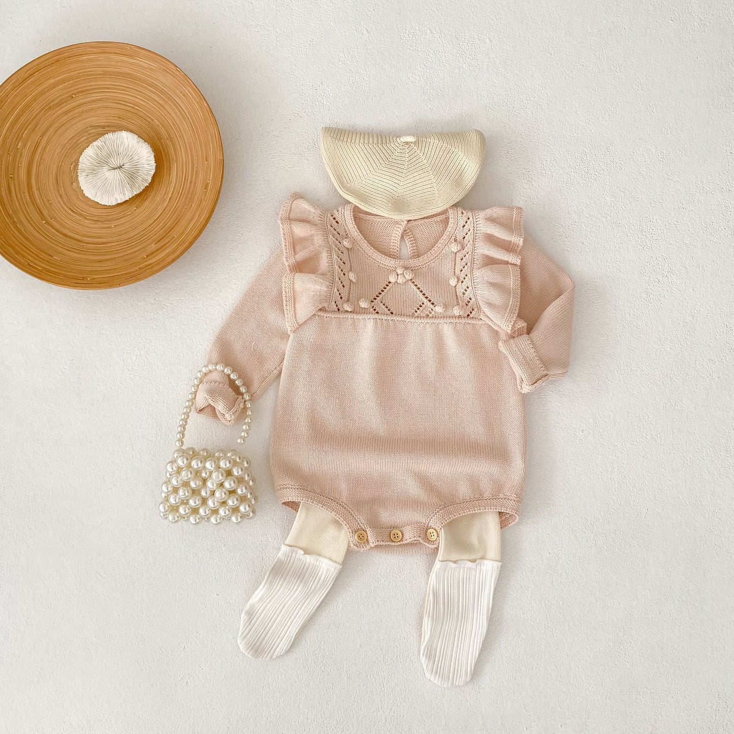 パステルピンクフリルニットロンパース